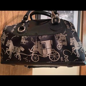 Coach purse with horse and carriage print.
